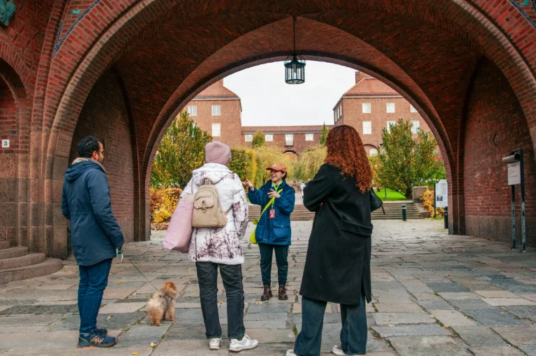 Tour group walking through a red-brick archway on the Stockholm Innovation Tour