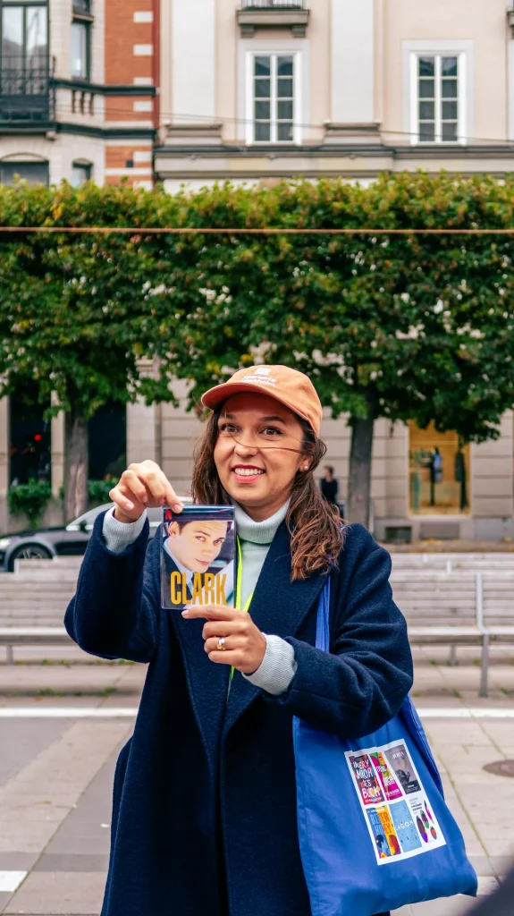 Ana holding up a book on the Lola Akinmade tour