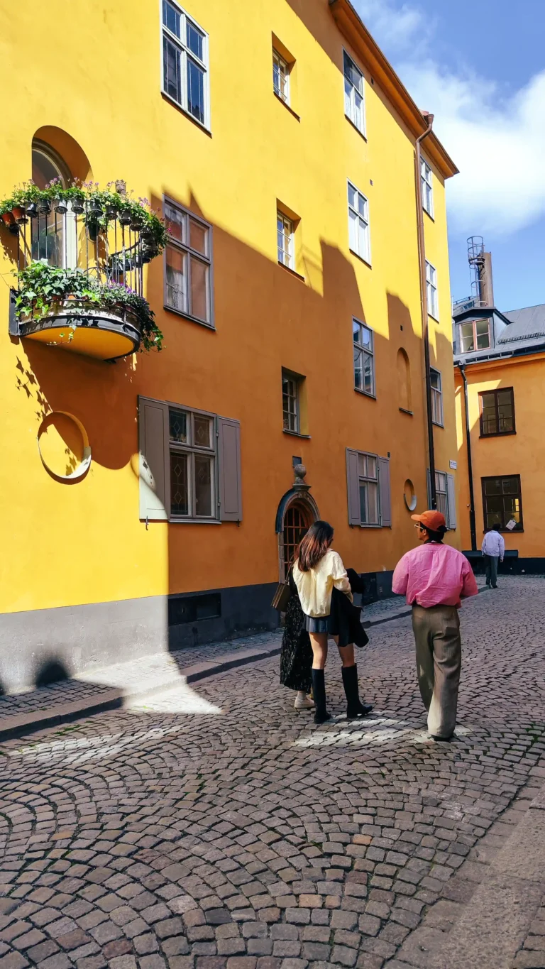 Yellow facades along a cobbled lane on Mingyang's Stockholm tour
