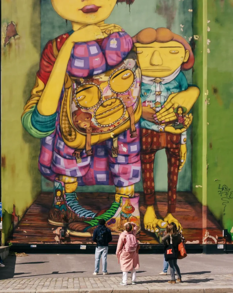 Guests in front of a giant colourful mural on Olesia's Stockholm tour