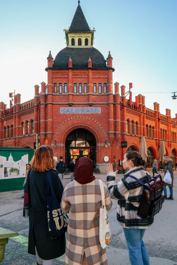 Tour group at a red-brick landmark on the Stockholm Architecture & Design Tour