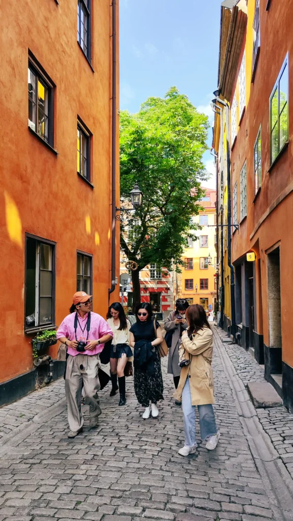 Guests walking a narrow cobbled lane on Mingyang's Stockholm tour
