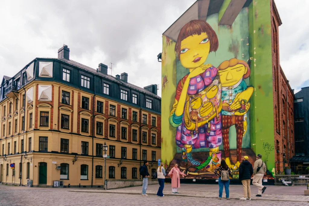 Giant Os Gemeos mural on a Stockholm building on the Urban Art Tour