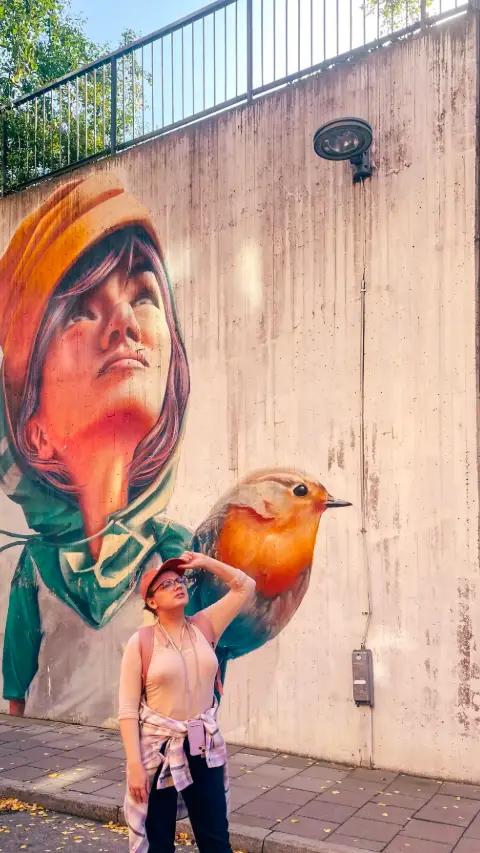 Street art mural of a woman and a bird in Södermalm